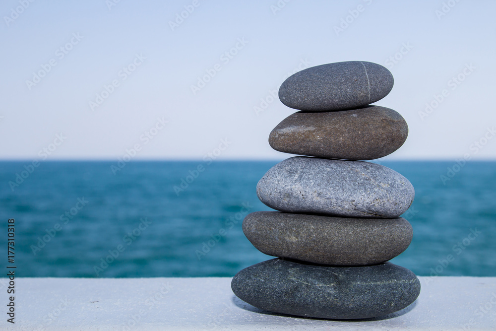 Cobblestone, a hill of stones, rocks energy. Landscape design with rocks with the sea background Cobblestone, a hill of stones, rocks energy. Landscape design with rocks with the sea background