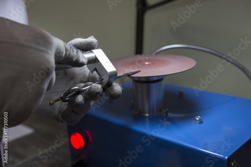 master man sharpens the machine scissors so they were sharp