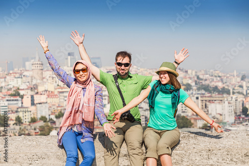Photography Group of multiracial happy Friends sitting near the mosque and enjoying view of