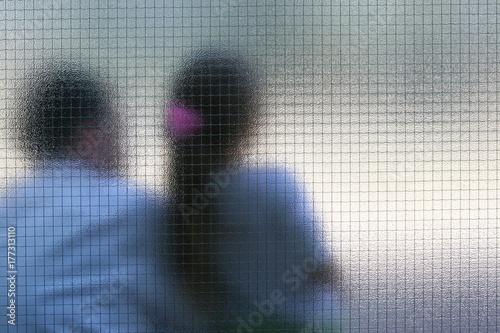 man and girl behind the glass door 
