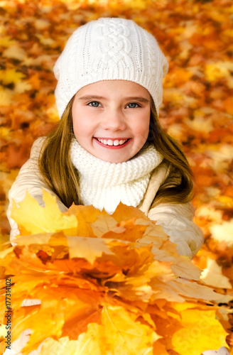 Autumn portrait of adorable little girl in hat