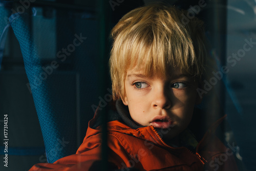 Boy gazes out to sea while on a ferry. photo