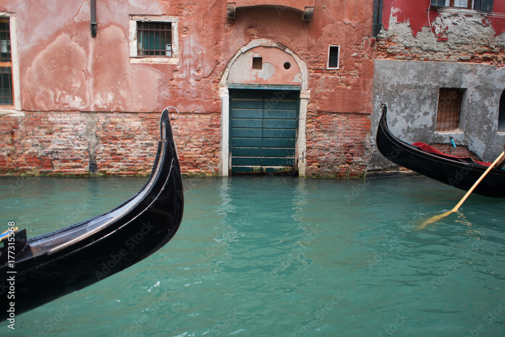 Gondolier floats on the narrow channel