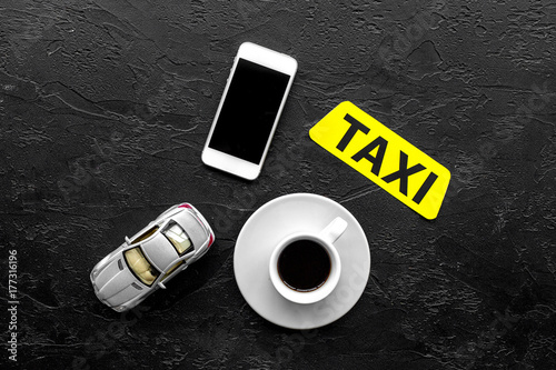 Order taxi online by mobile phone. Black background top view copyspace