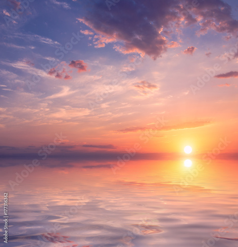 Beautiful sunset over calm water. © Sviatoslav Khomiakov