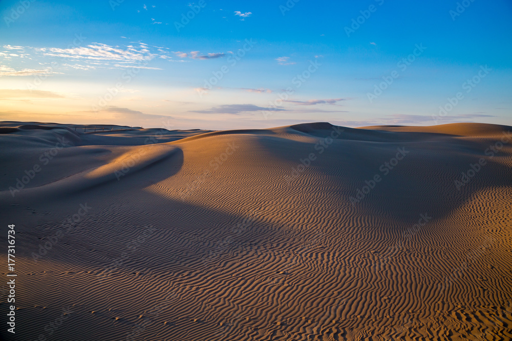 Natural beautiful desert landscape, sand dunes on blue evening sky background