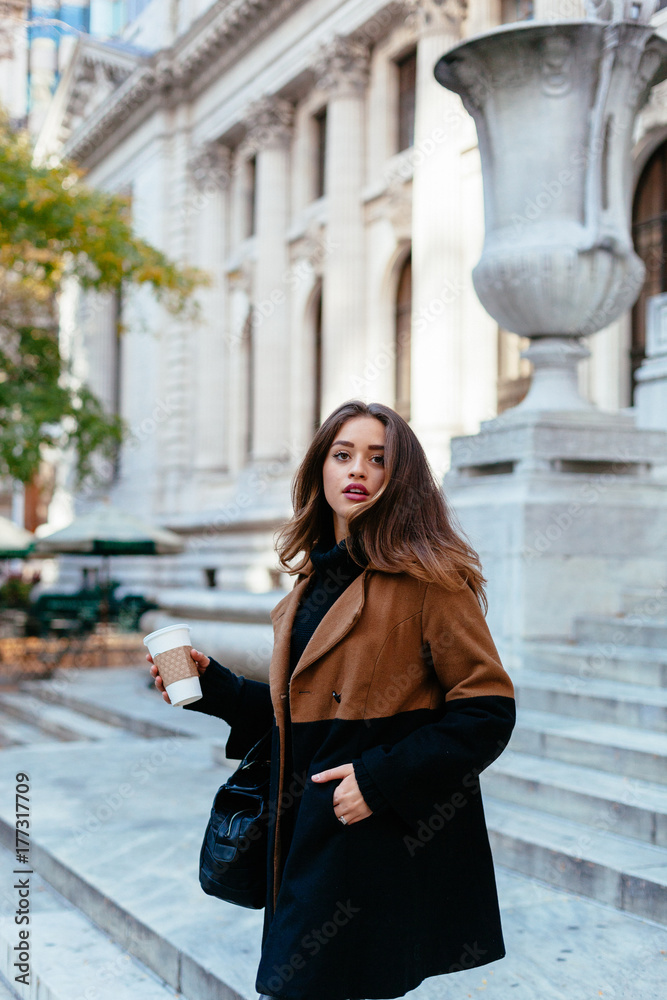 Woman having a coffee to go in New York Woman having a coffee to go in New York