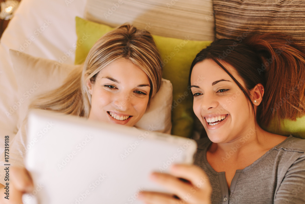 Roommates Using a Digital Tablet in Bed Roommates Using a Digital Tablet in Bed