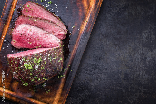 Barbecue wagyu point steak sliced as close-up on a cutting board with copy space photo