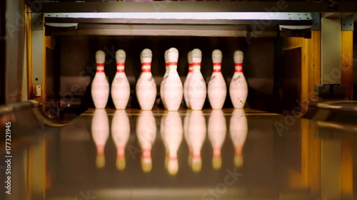 Bowling ball knocking pins on the bowling lane. Slow motion
