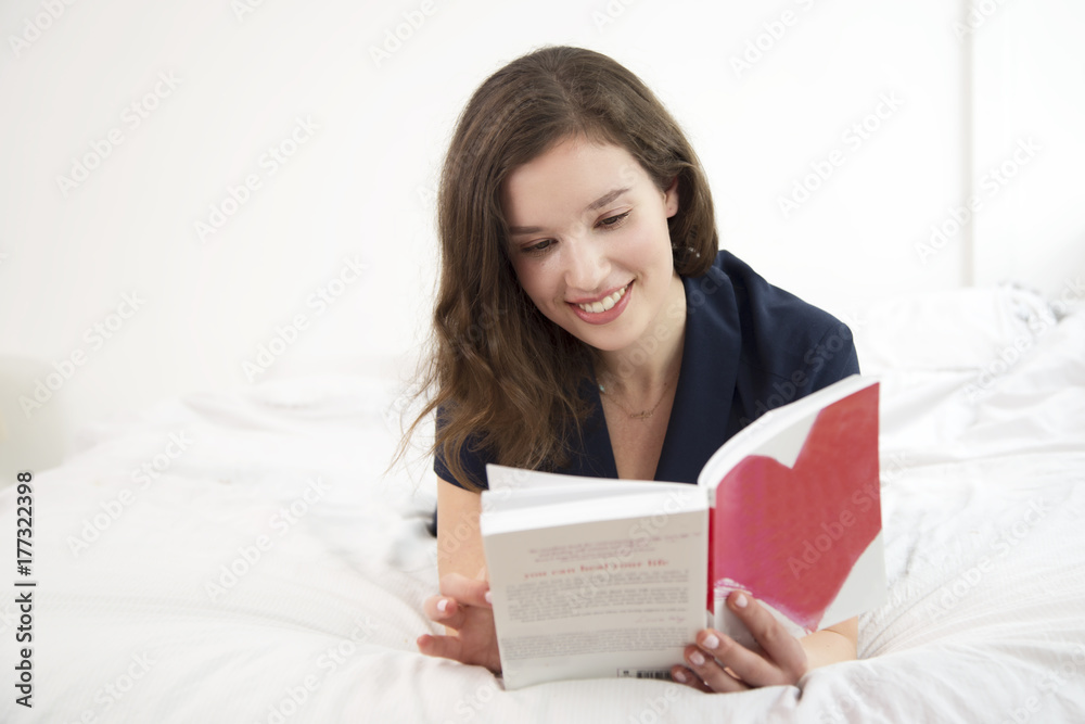 young woman reading a book at home young woman reading a book at home