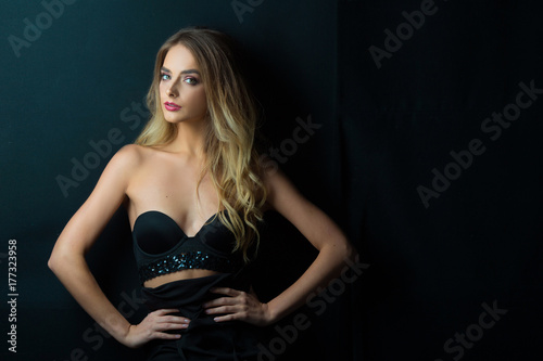 young beautiful sensual girl with makeup and hairdress on a black background © Alexandr