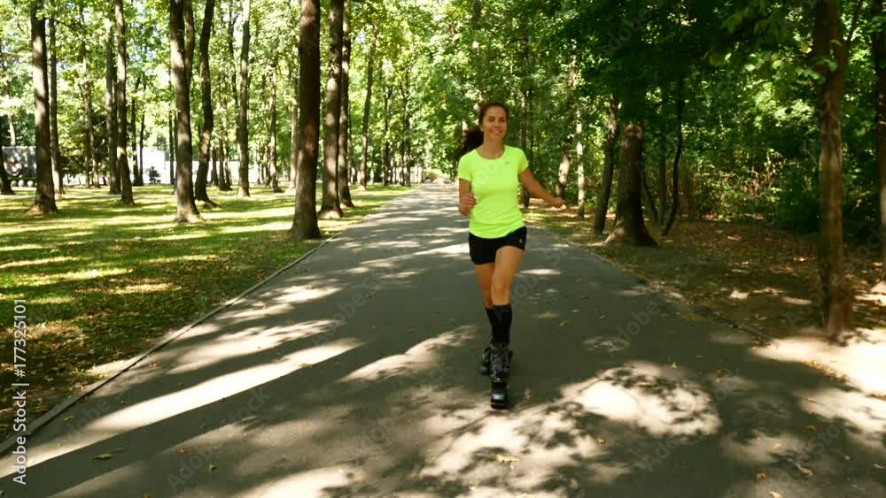 Young beautiful girl doing sports in the park. A woman jumps on special shoes for fitness. Young beautiful girl doing sports in the park. A woman jumps on special shoes for fitness.