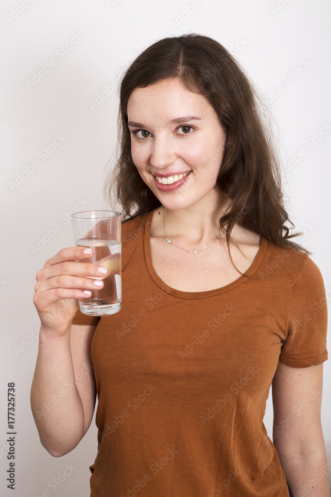 young woman holding a glass of water young woman holding a glass of water