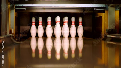 Bowling ball knocking pins on the bowling lane. Slow motion