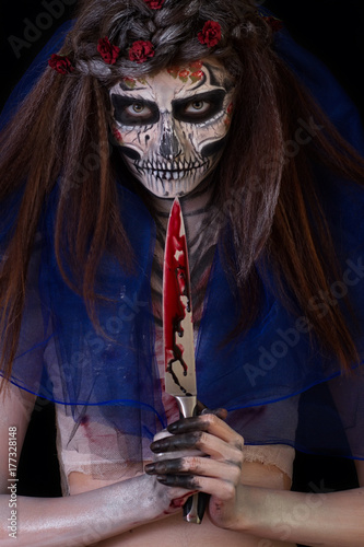 Beautiful girl with scary Halloween make-up