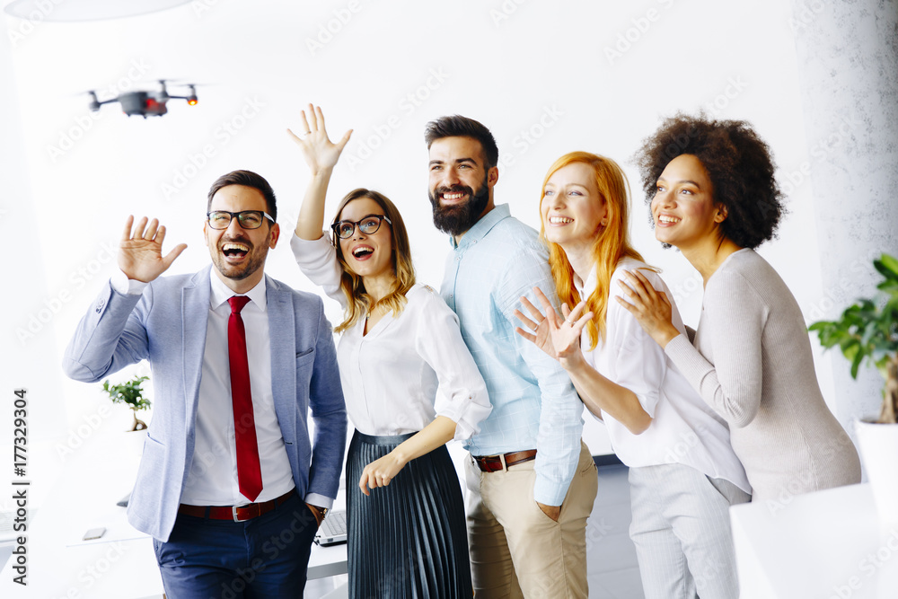 Young business people letting the drone camera to fly over the office Young business people letting the drone camera to fly over the office