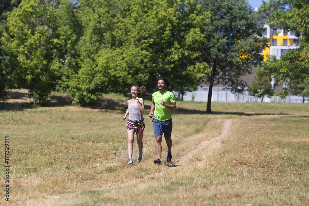 Healthy, fit and sportive couple running in park Healthy, fit and sportive couple running in park