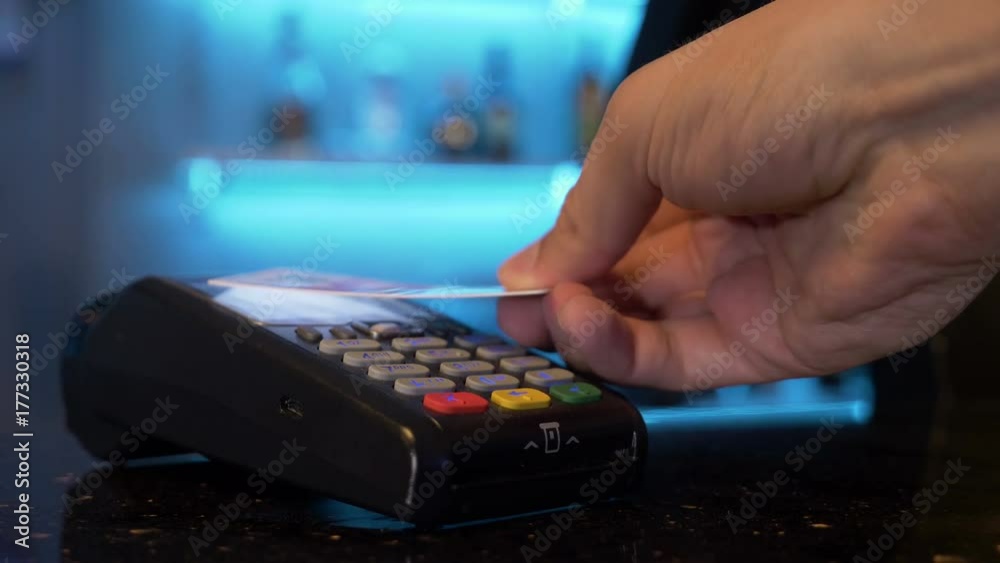 Customer using credit card over pos module for cashless contactless payment for shopping