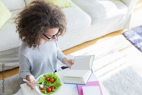 Curly hair teen girl readin...