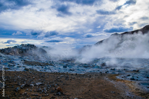 Scenic geothermal area Hverir (Hverarond) near Mývatn lake in North Iceland. Impressive landscape with field of bubbling mud pools and steaming fumaroles.