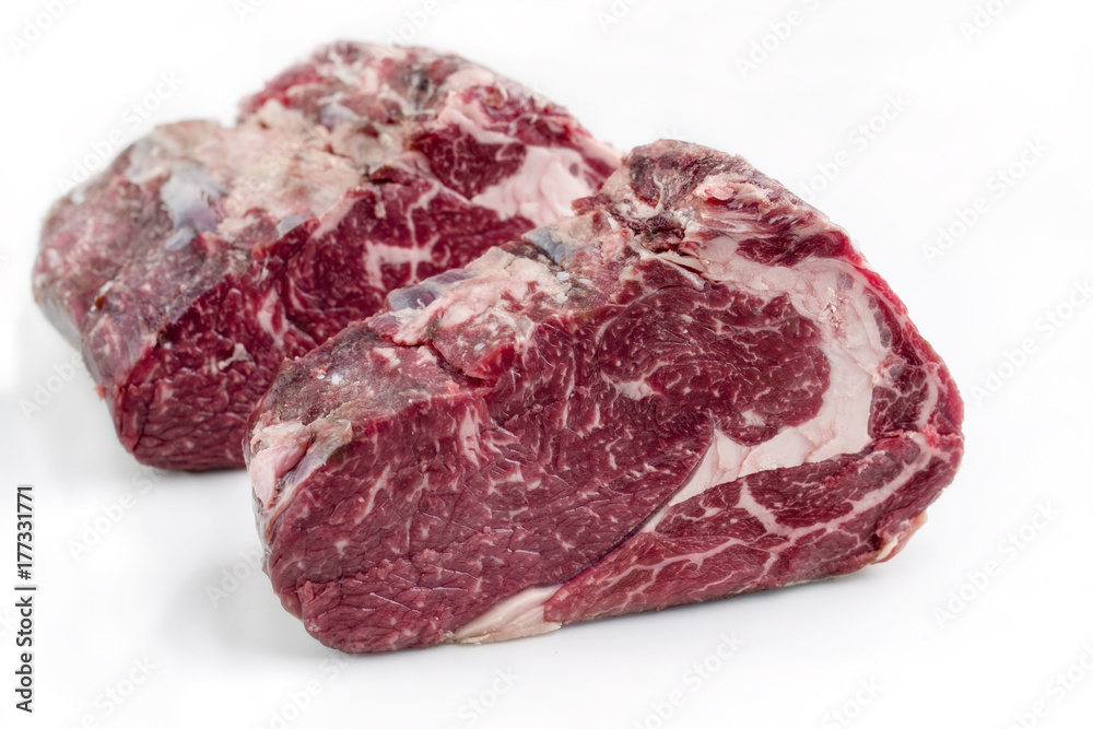 Two Raw dry aged Kobe rib eye Steak as close-up – covered