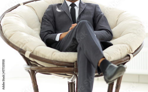confident businessman sitting in a large comfortable chair. © ASDF