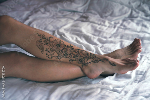 Henna body art at lady's legs photo