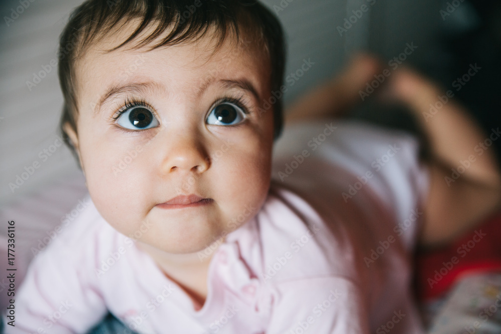Cute baby girl portrait, lying down on nappy changing unit Cute baby girl portrait, lying down on nappy changing unit
