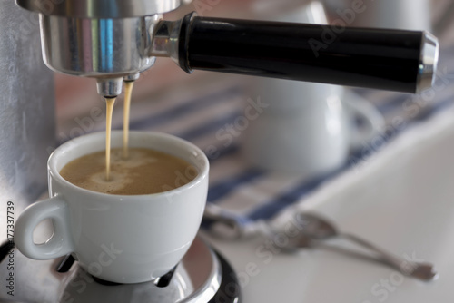 Professional coffee machine making espresso at home