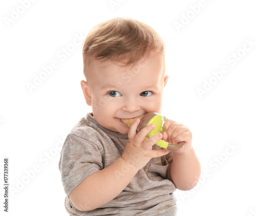 Adorable little baby with nibbler on white background
