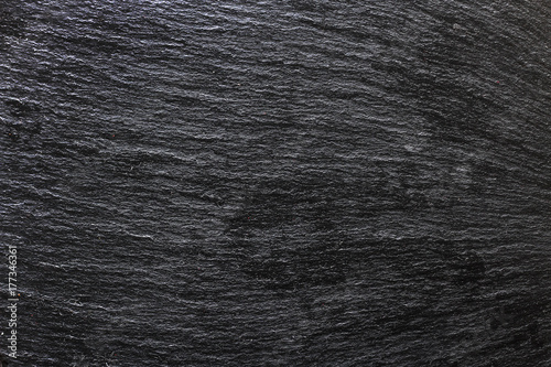 Black metal texture - a view of the smooth line under the black stone