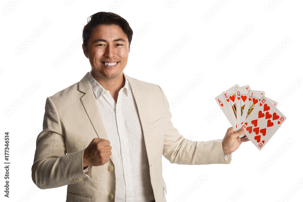 Laughing man wearing a beige suit holding a fan of cards in his hands showing a royal flush. White background. Laughing man wearing a beige suit holding a fan of cards in his hands showing a royal flush. White background.