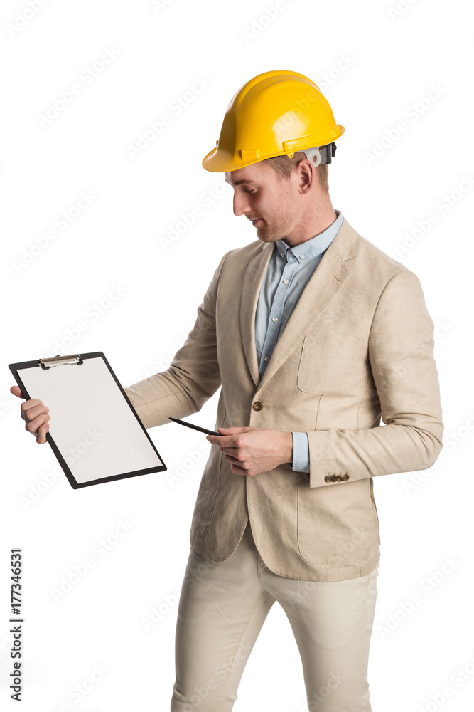 Handsome construction worker wearing a bright blazer holding a clipboard with a yellow safety helmet on his head. White background. Handsome construction worker wearing a bright blazer holding a clipboard with a yellow safety helmet on his head. White background.
