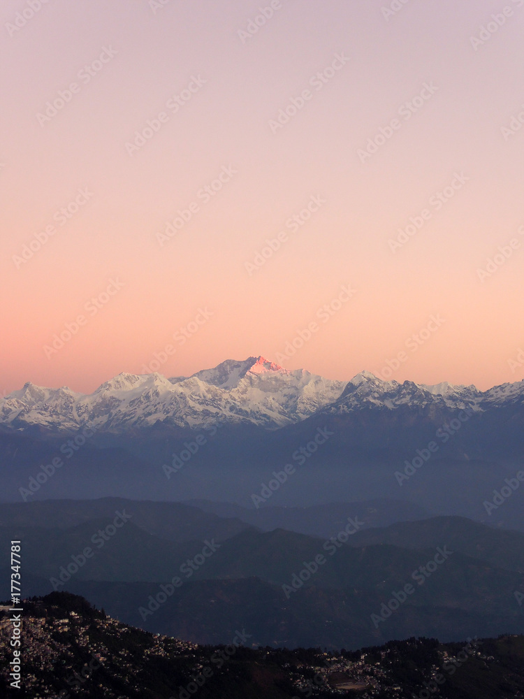 First rays of sun hit the peak of Mt. Kanchenjunga First rays of sun hit the peak of Mt. Kanchenjunga
