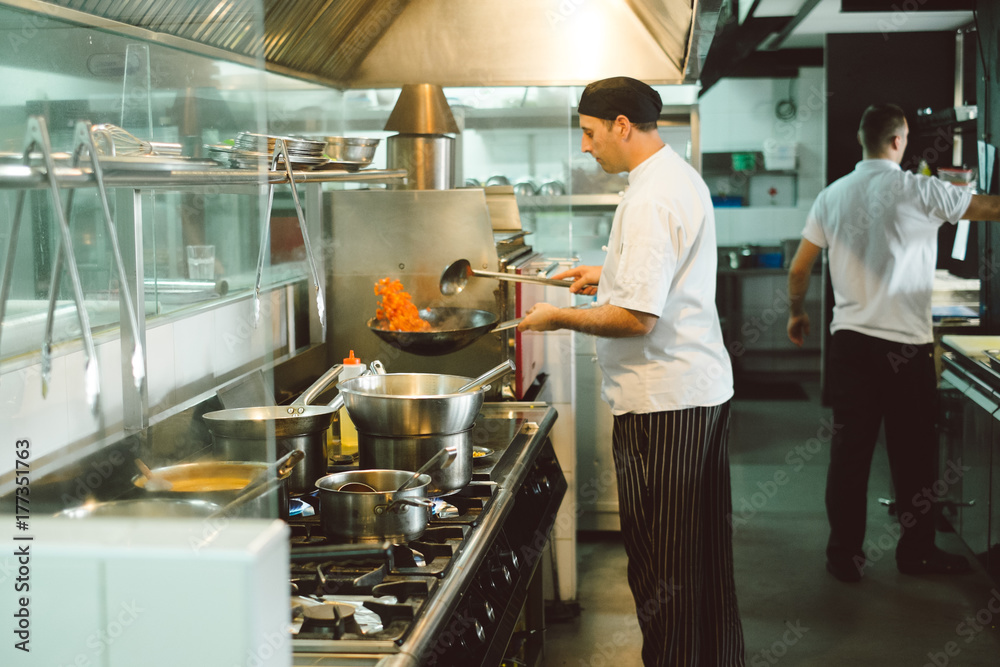 Chef preparing food at the restaurant kitchen Chef preparing food at the restaurant kitchen