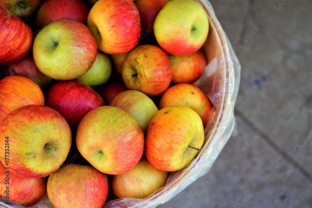 Fresh red and yellow apples in barrels at the farmers market in the fall Fresh red and yellow apples in barrels at the farmers market in the fall