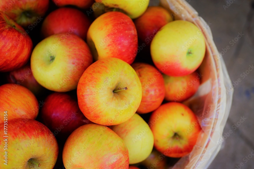 Fresh red and yellow apples in barrels at the farmers market in the fall Fresh red and yellow apples in barrels at the farmers market in the fall