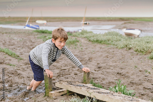 Cheeky child stuck in the mud