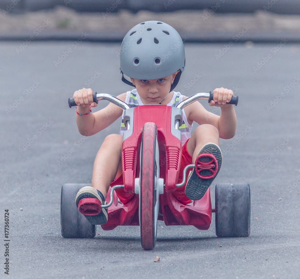 Young Boy Riding a Tricycle Stock Photo Adobe Stock