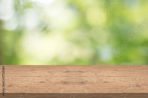 Wood table top on nature green blurred background,for montage your products