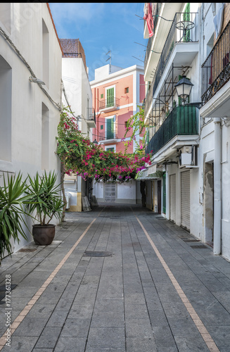 Typical empty street in old town of Ibiza, Balearic Islands, Spain. Morning light. Wide angle