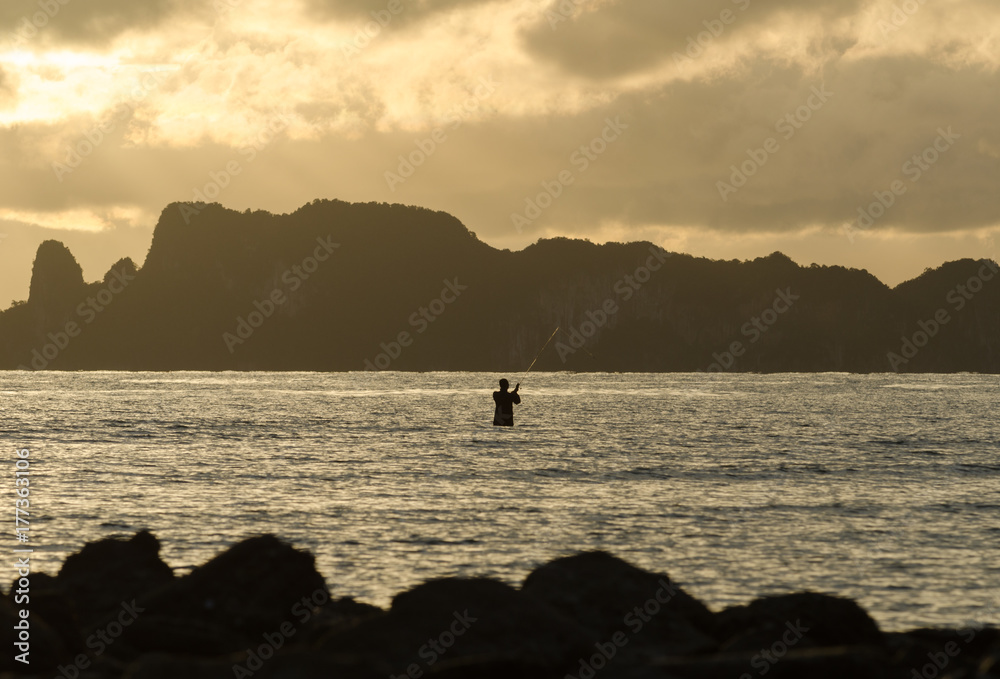 Fisherman fishing in the sea at Krabi, Thailand