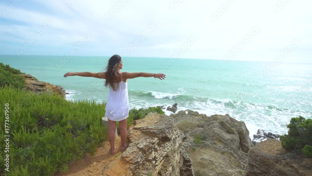 Beautiful woman with the arms raised alone in nature Beautiful woman with the arms raised alone in nature
