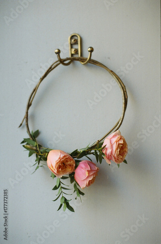 The bride's diadem of roses in rustic style  on the wall hook