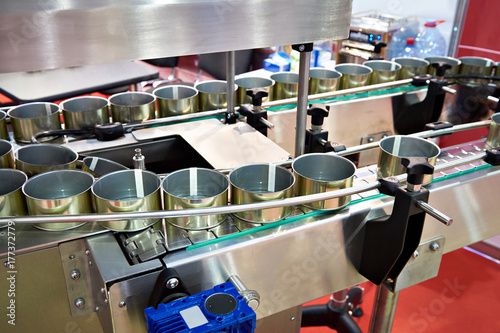 Empty cans on conveyor of food factory