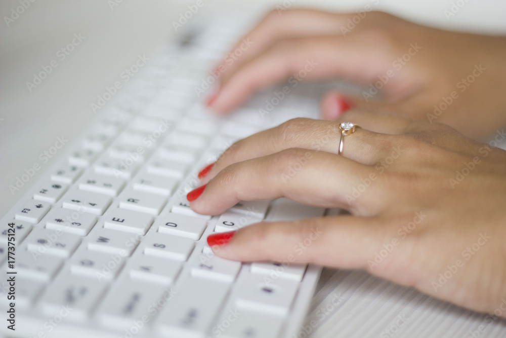 Female hands typing on white computer keyboard Female hands typing on white computer keyboard