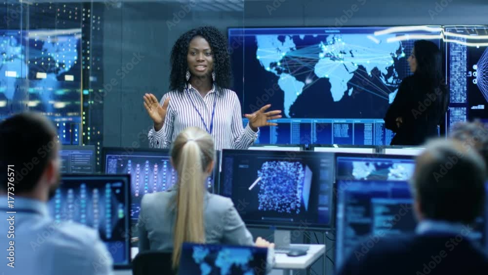 Chief Project Engineer Holds Briefing for a Team of Scientists that are Building Machine Learning System. Displays Show Working Model of Neural Network. 