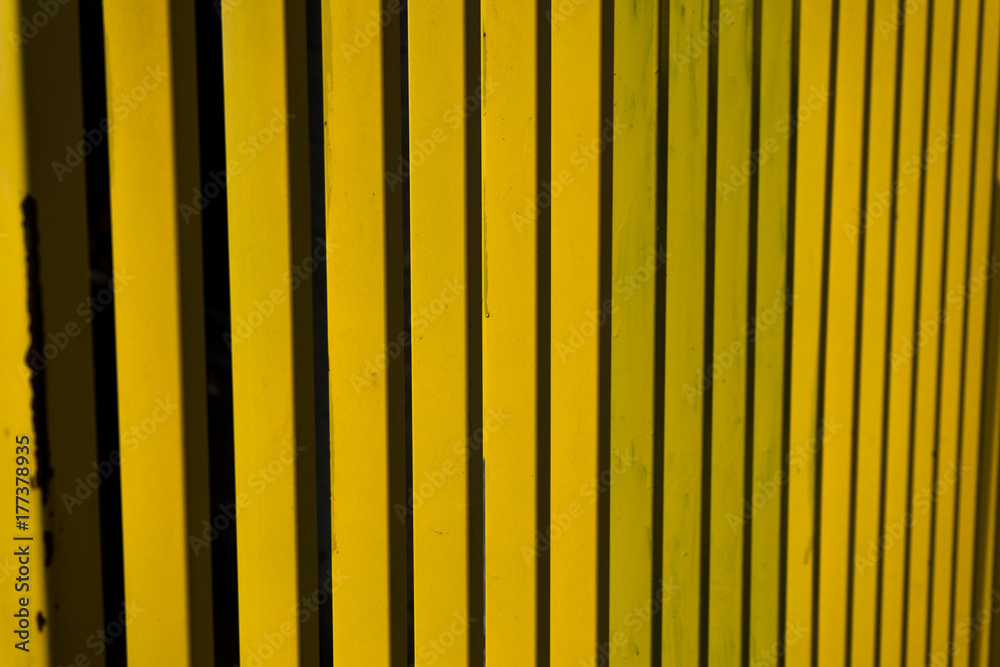 Yellow metal fence abstract stripes