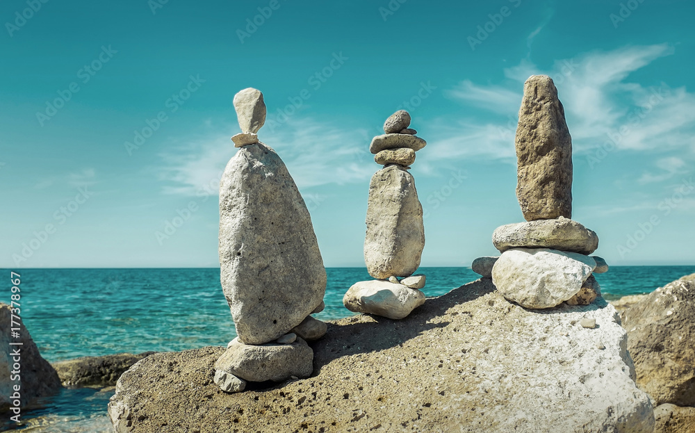 Composition of stones on the seacost under blue sku with clouds Composition of stones on the seacost under blue sku with clouds